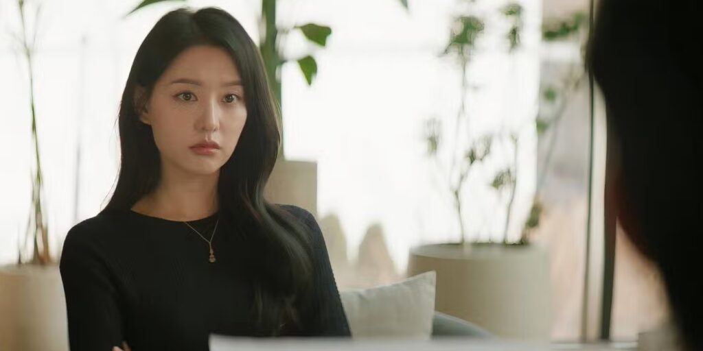 The main female character Hong Hae-in is sitting in her office and in sad mood