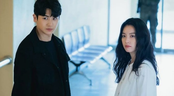 The main male and female lead are staring at someone with anxiety in Happiness Korean drama
