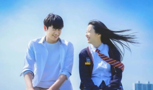 The two main leads are sitting on the roof and laughing together in Happiness Korean drama