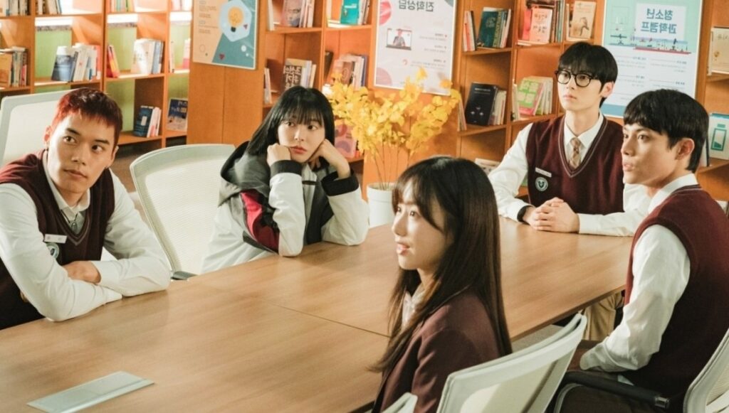 All the main leads of Study Group are sitting in their classroom and seeing toward the board
